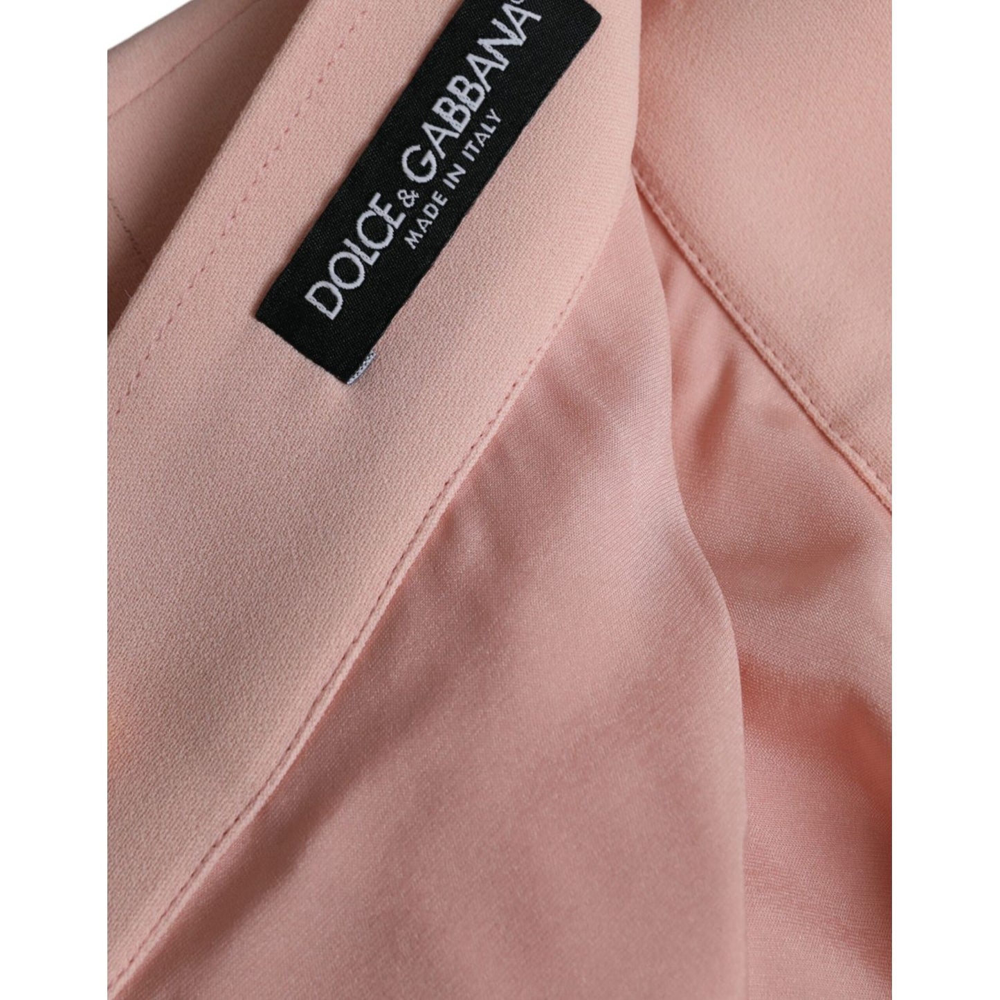 Close-up of tag on Dolce & Gabbana Light Powder Rose Viscose Pleated Skirt in luxurious fabric.
