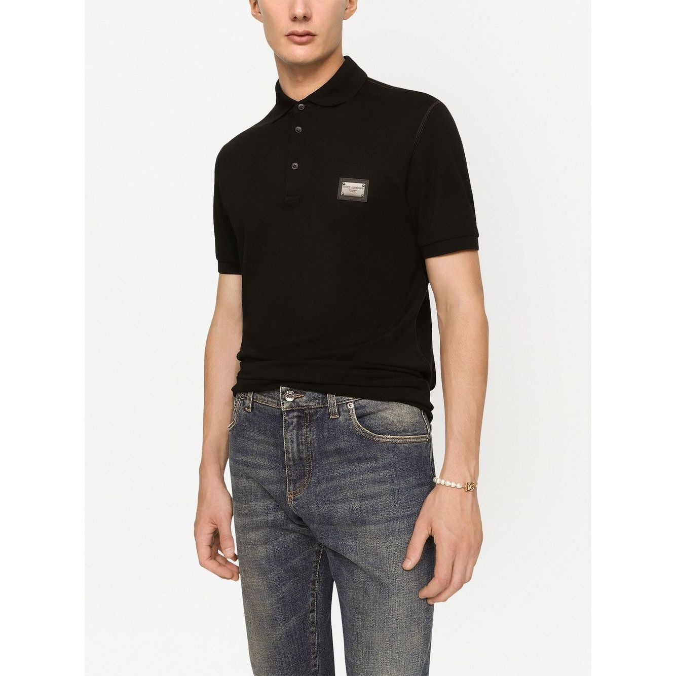 Dolce & Gabbana Logo cotton polo shirt in black cotton piqué weave with silver-tone logo plaque, short sleeves, and front button placket.