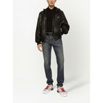 Model wearing Dolce & Gabbana Logo cotton polo shirt in black, paired with leather jacket and jeans