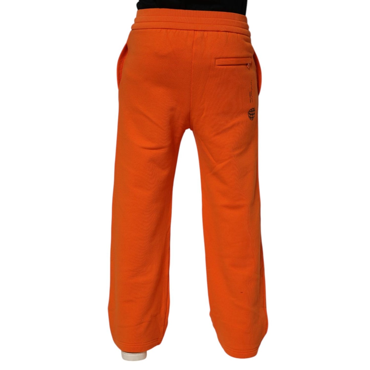 Back view of Dolce & Gabbana Orange Cotton DG VIB3 Logo Drawstring Sweatpants Pants showcasing rear pockets and bold color.