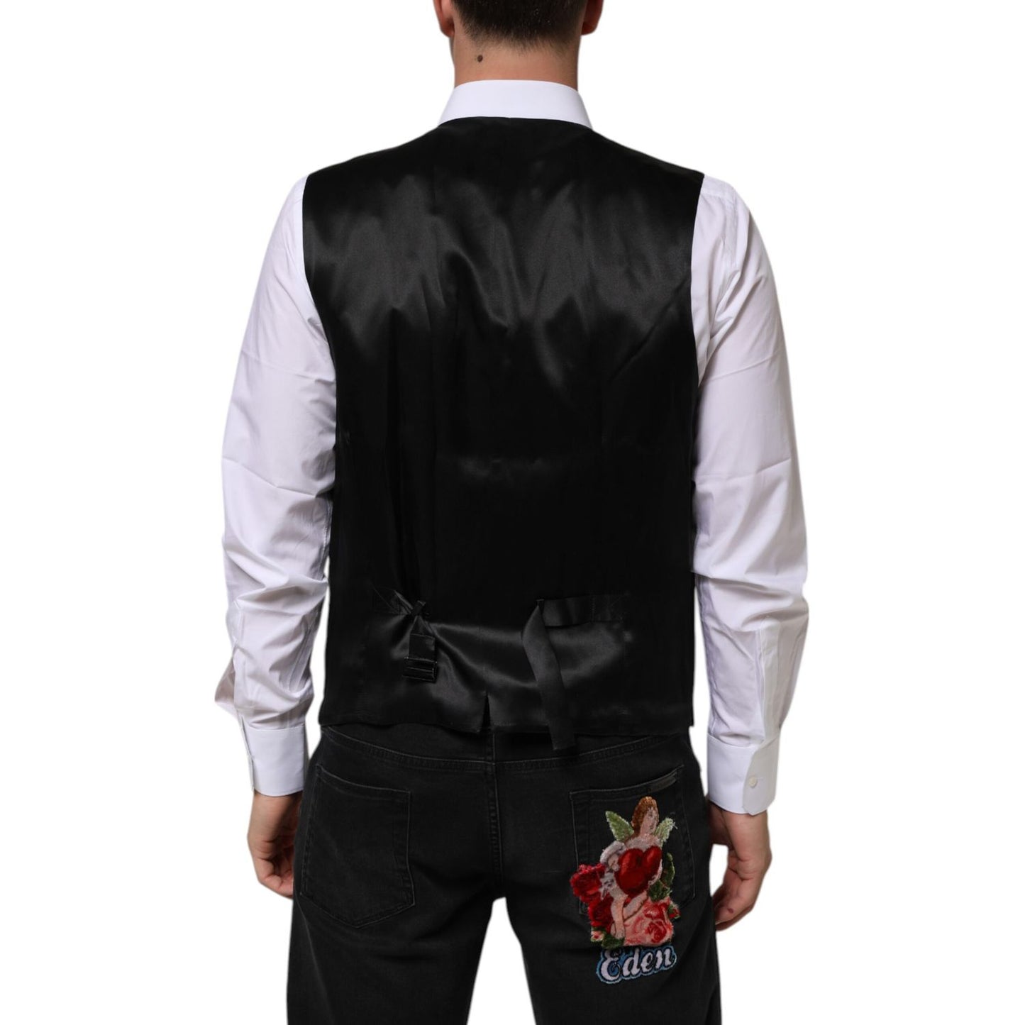 Back view of a man wearing Dolce & Gabbana Purple Wool Dress Formal Waistcoat Vest with adjustable strap, paired with embroidered jeans.