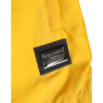 Dolce & Gabbana Yellow Nylon Logo Plaque Boxer Shorts Swimwear with iconic logo plaque detail on yellow fabric.