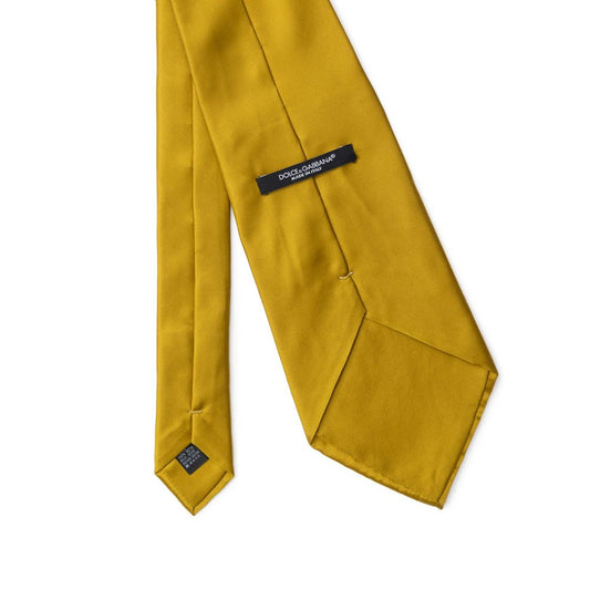 Dolce & Gabbana Yellow Silk Ty in mustard with pointed end and brand logo label. Made in Italy from silk. Blade width: 12 cm.