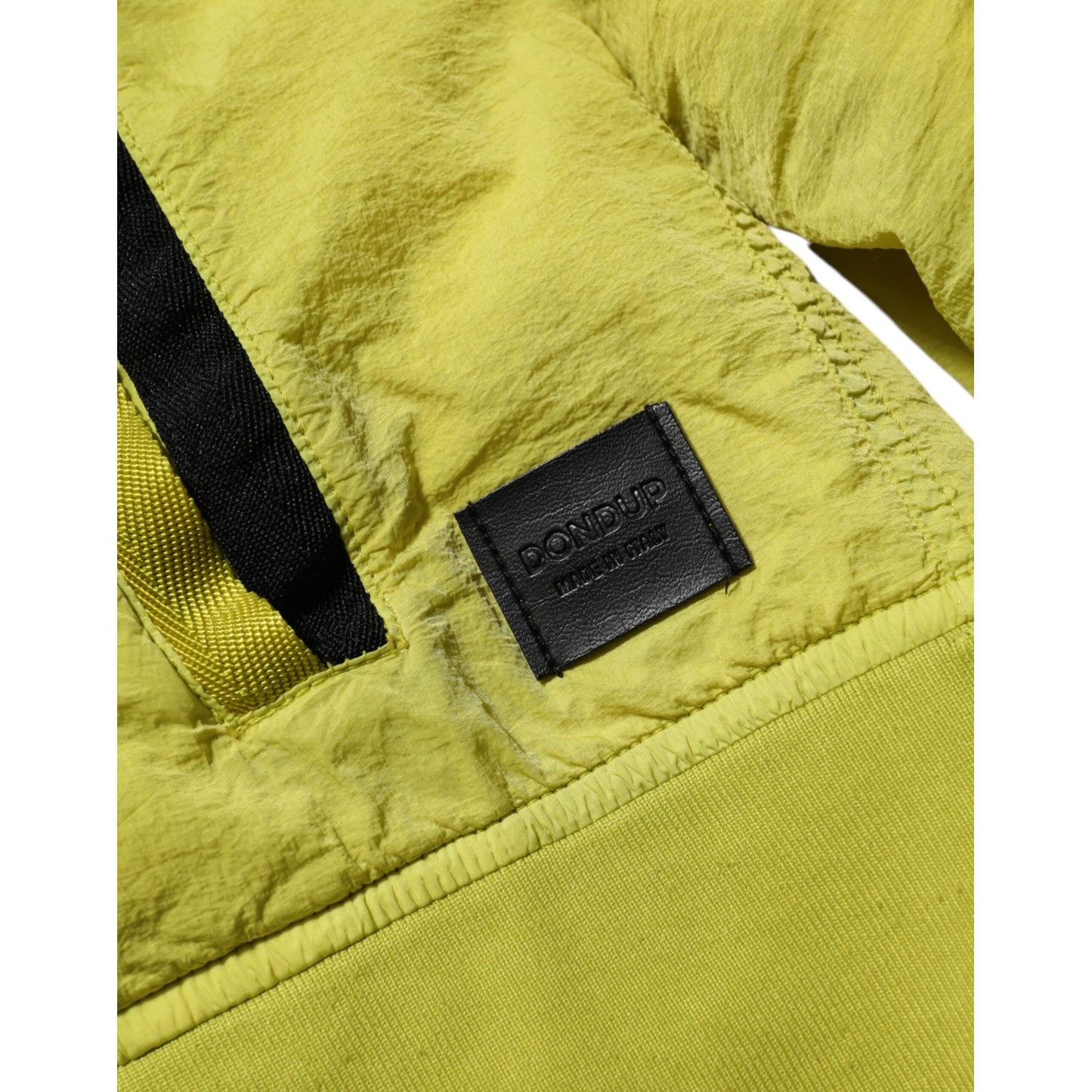 Close-up of Dondup Yellow Polyamide Zipper Bomber Women’s Jacket with logo and ribbed trim detail.
