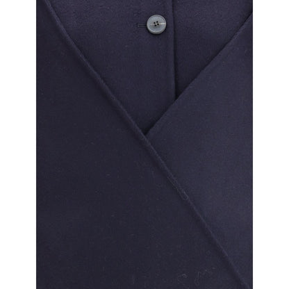 Close-up of Dynamis Studio Blue Wool Coat, highlighting button closure and fabric texture.