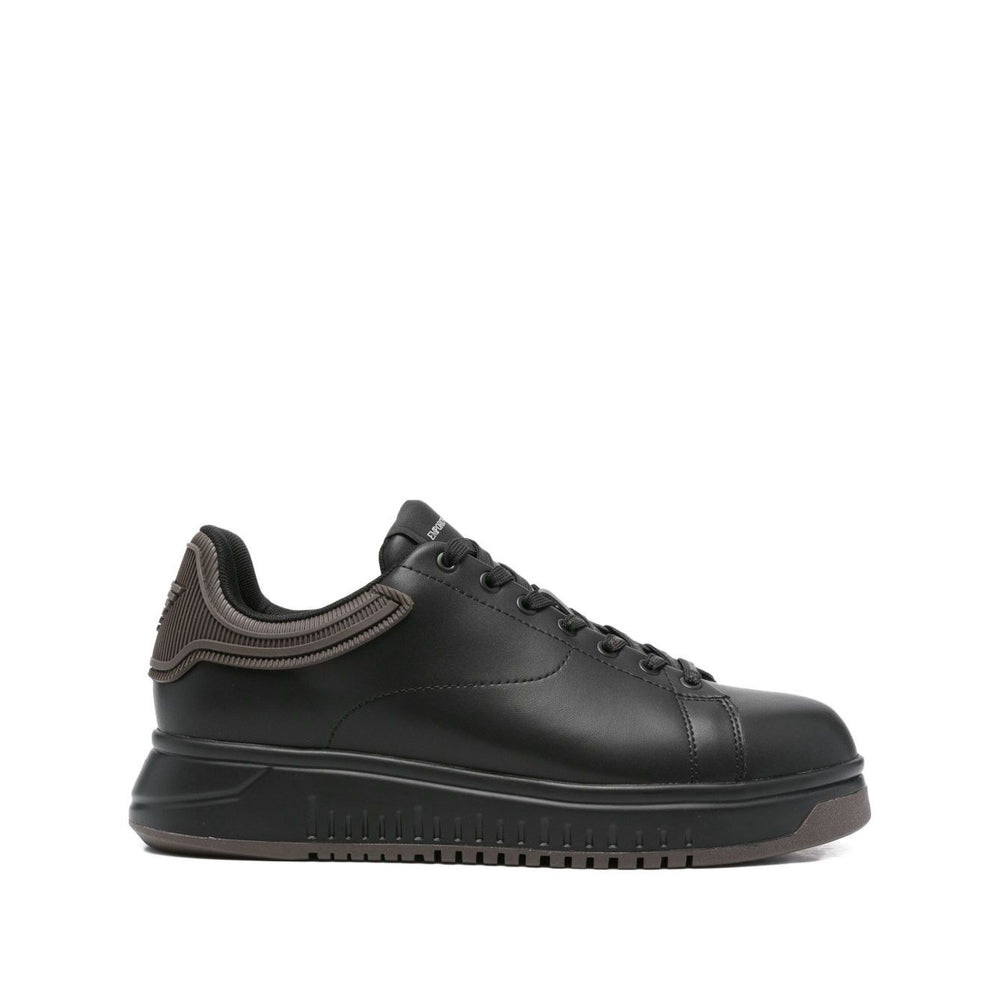 EMPORIO ARMANI EXCLUSIVE Lace-up low-top sneakers, black leather with ribbed panel and flat rubber sole, featuring tonal stitching.