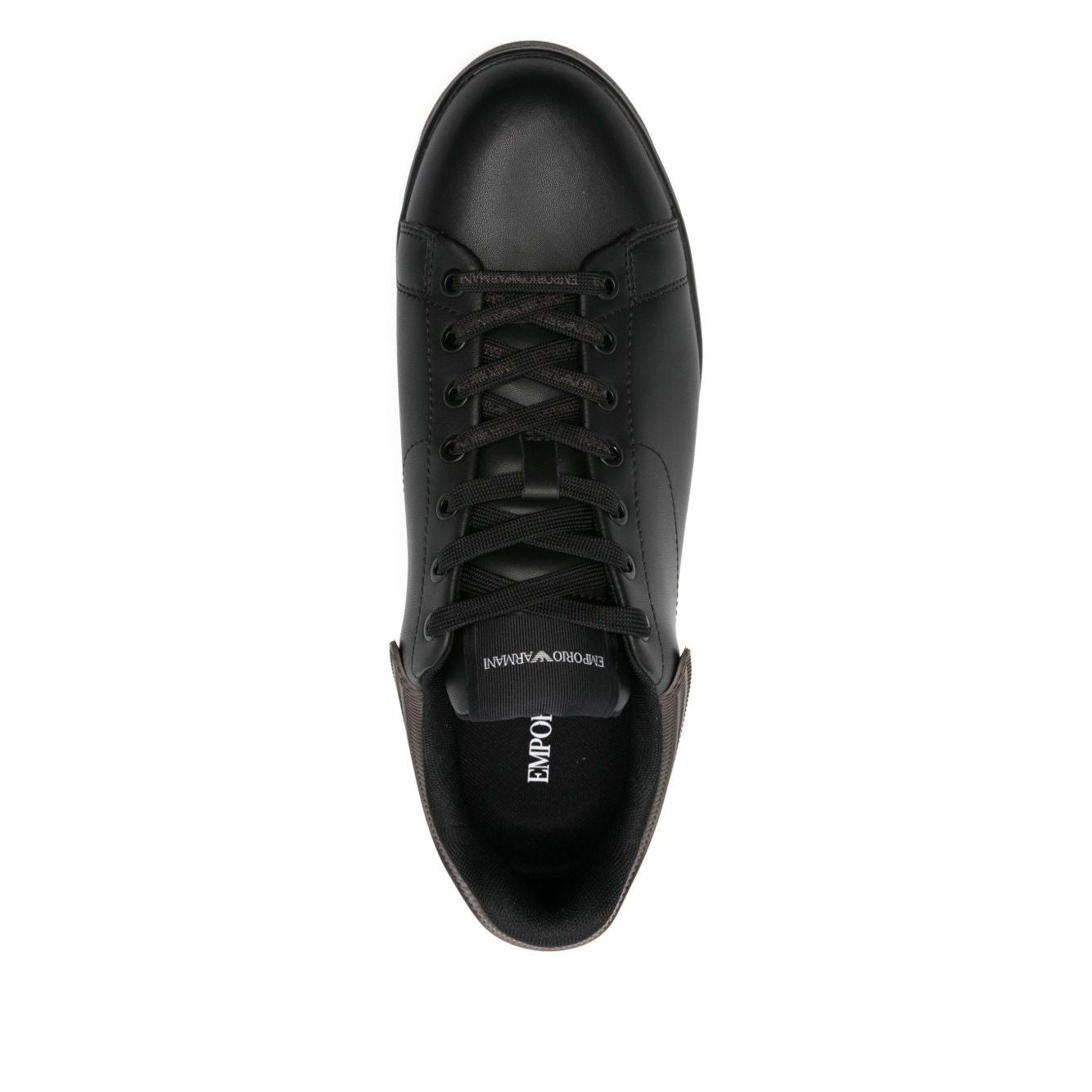 Top view of black leather EMPORIO ARMANI EXCLUSIVE Lace-up low-top sneakers with ribbed panels and flat rubber sole.