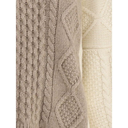Close-up of Ella Cream Cashmere Cashmere Sweater's two-tone cable-knit texture, showing detail and craftsmanship.