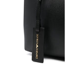 Close-up of Emporio Armani MyEA small shopping bag with black faux leather texture and gold debossed logo tag.