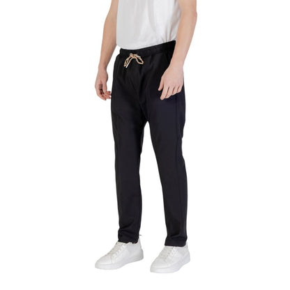 Model wearing Gianni Lupo Black Polyester Casual Pants with white sneakers and white shirt.