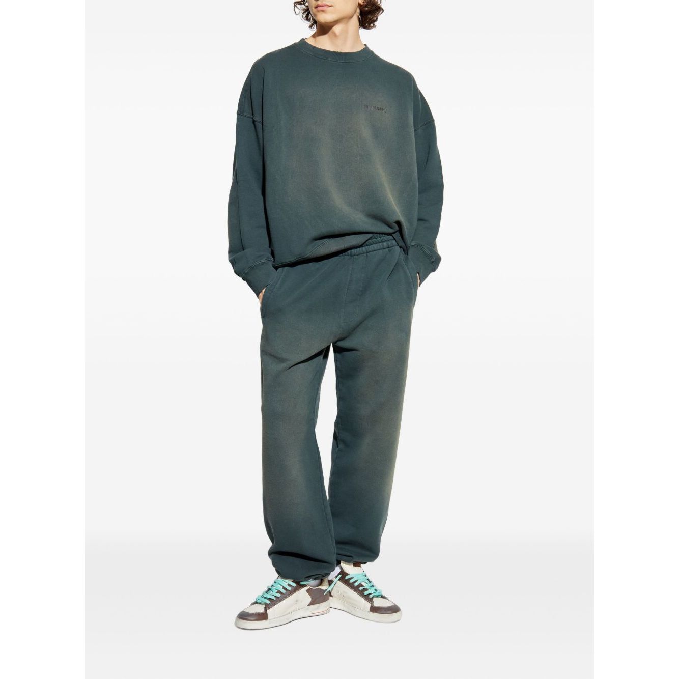 Golden Goose Trousers Black with blue elasticated waistband, side welt pockets, and embroidered logo, shown worn by model with sneakers.