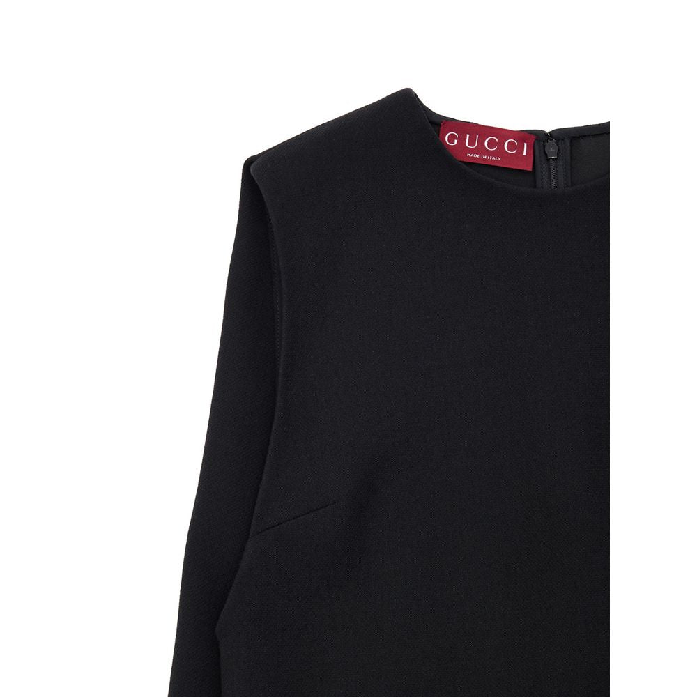 Gucci Black Wool Dress featuring short sleeveless bell design, side pockets, and zip back. 60s-inspired with logo embroidery.