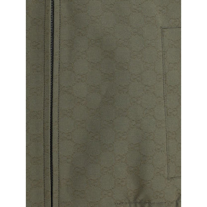 Close-up of Gucci Green Cotton Bomber featuring GG Supreme pattern with a zipper and side welt pocket detail.