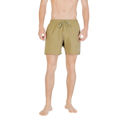 Model wearing Hugo Boss Green Polyester Swim Shorts with adjustable waistband, showcasing durability and comfort for beach or pool days.