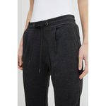 Woman wearing ICHI Gray Polyester Pant with drawstring waistband and front pleats for modern style and comfort.