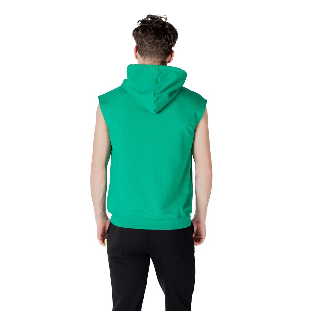 Back view of a man wearing an Icon Green Cotton Hoodie, showcasing the sleeveless design and hood.