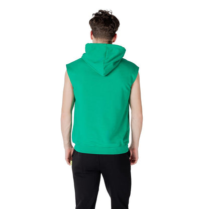 Back view of a man wearing an Icon Green Cotton Hoodie, showcasing the sleeveless design and hood.