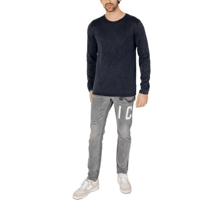 Model wearing Jack Jones Blue Cotton Sweatshirt with jeans, showcasing a casual refined style, made from 100% cotton for comfort.