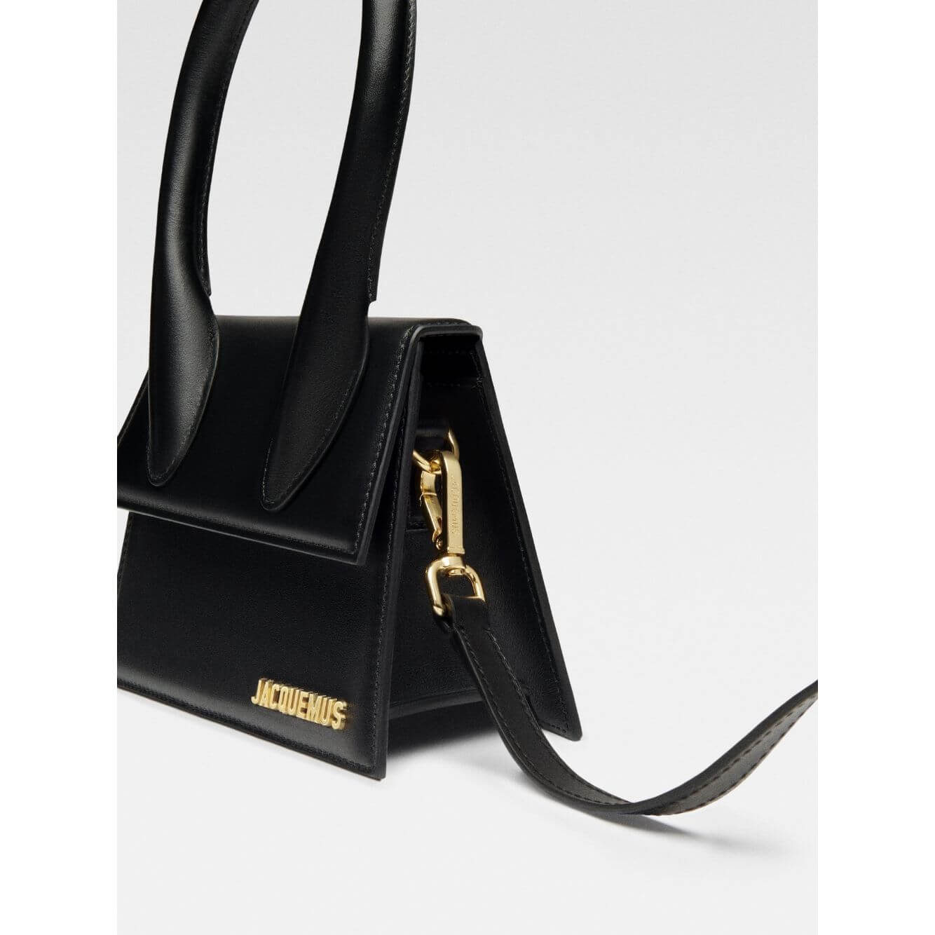 Side view of Jacquemus Le Chiquito Moyen Black Bag with gold hardware and detachable strap.