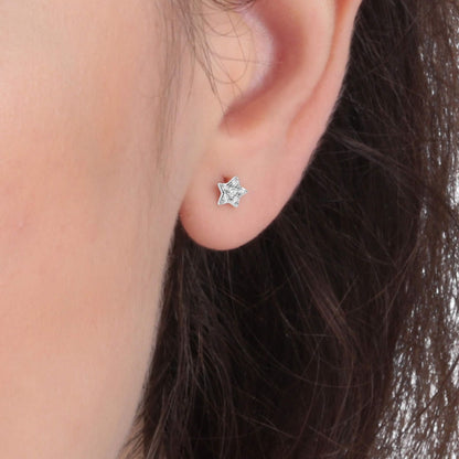 Silver stud earring in star shape by LA PETITE STORY JEWELRY Mod. LPS02ARQ03, worn on woman's ear