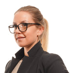 Woman wearing stylish black-framed glasses and a black blazer, looking to the side, isolated on a white background.