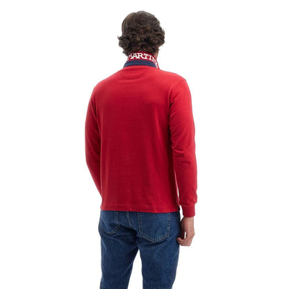 Rear view of model wearing La Martina Red Cotton Polo Shirt with long sleeves and embroidered collar, paired with blue jeans.