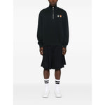 Model wearing Maison Kitsuné MAISON KITSUNE' Sweaters Grey featuring half zip, fox motif, and ribbed cuffs.