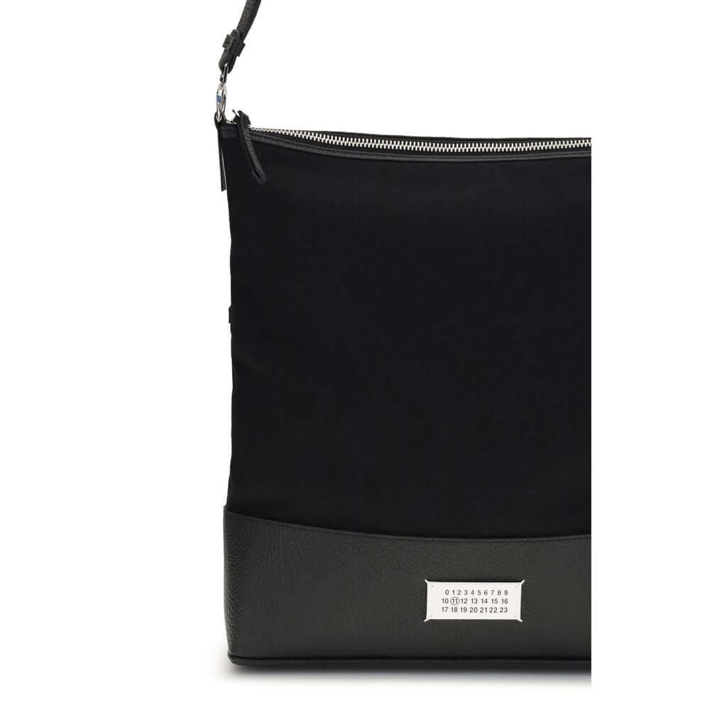 Margiela Black Cotton Shoulder Bag with leather strap and front numeric label. Features zipper closure and signature Maison Margiela stitches.
