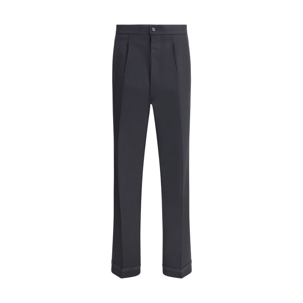 Margiela Black Wool Dress Pants with pleated design and logo closure, featuring elegant turn-ups and welt pockets for functional style.