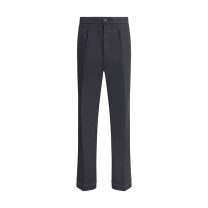 Margiela Black Wool Dress Pants with pleated design and logo closure, featuring elegant turn-ups and welt pockets for functional style.
