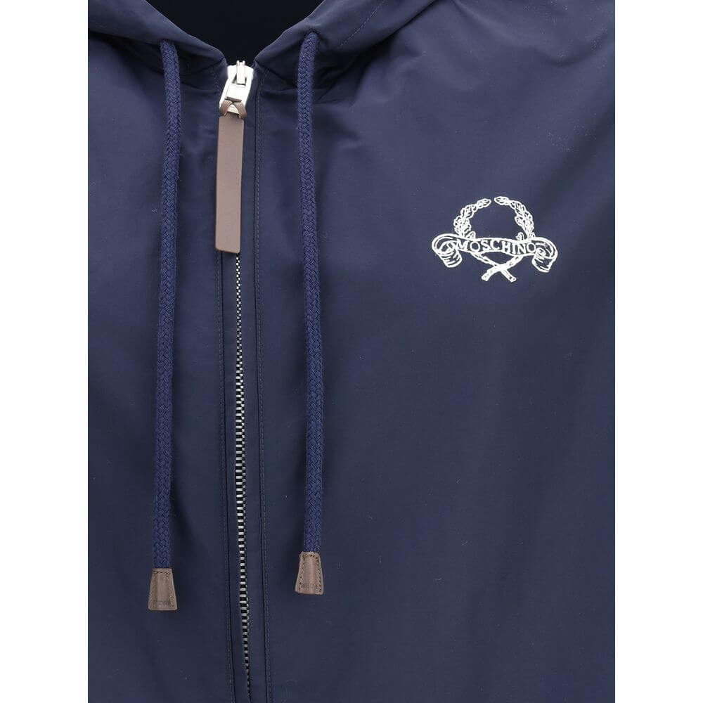Close-up of Moschino Blue Polyester Shell Jacket showing logo embroidery and zipper design details.