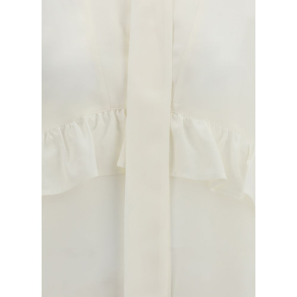 Close-up of P.A.R.O.S.H. Cream Silk Blouse showing detailed ruffles and bow embellishment, perfect for elegant seasonal wear.