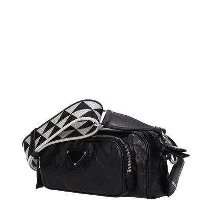 Prada Black Leather Crossbody Bag with silver details, front logo, adjustable black and white strap, featuring zip closure and pockets.