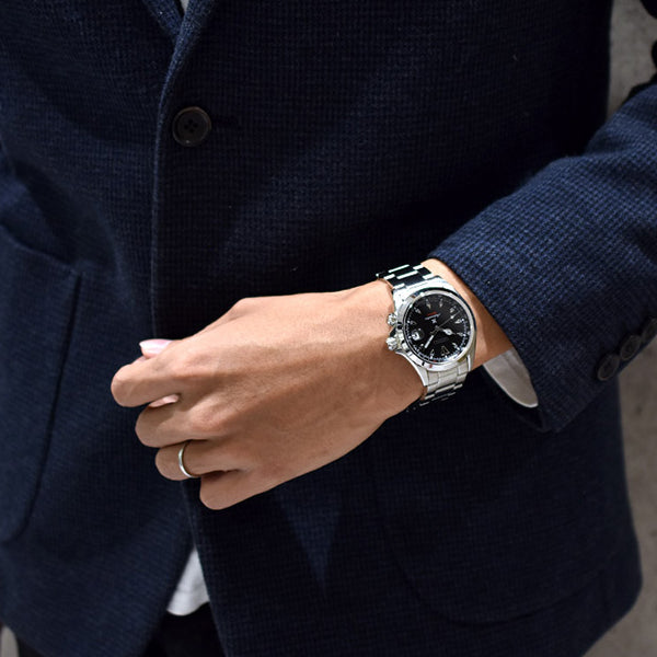 Man wearing SEIKO Mod. SPB117J1 wristwatch with stainless steel case and strap, featuring a sapphire dial, 20 ATM water resistance, and automatic movement.