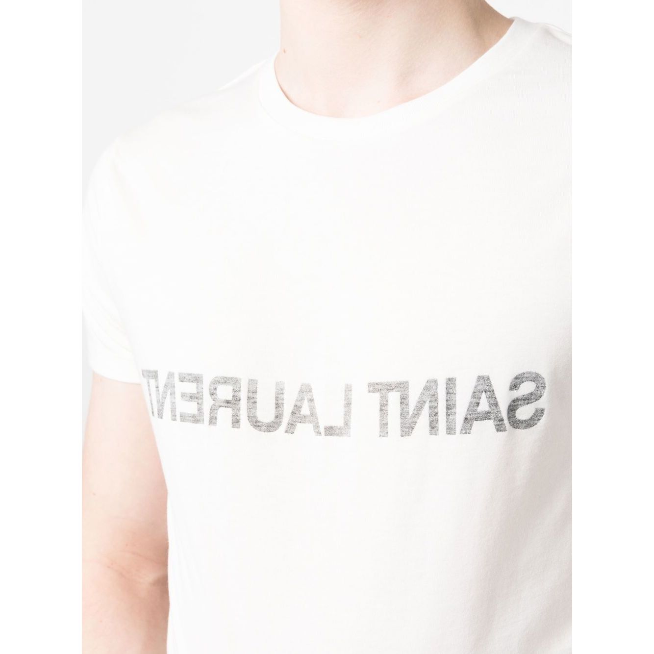Man wearing a white Saint Laurent Logo T-shirt with reverse logo print, round neck, short sleeves, made of cotton.