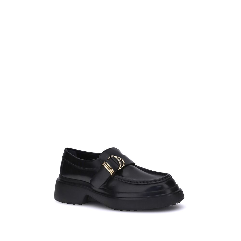 Tod's Black Rubber Platform Loafers with metal rings and soft nappa leather, featuring a contemporary platform sole, elegant and versatile.