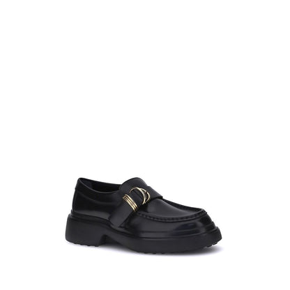 Tod's Black Rubber Platform Loafers with metal rings and soft nappa leather, featuring a contemporary platform sole, elegant and versatile.