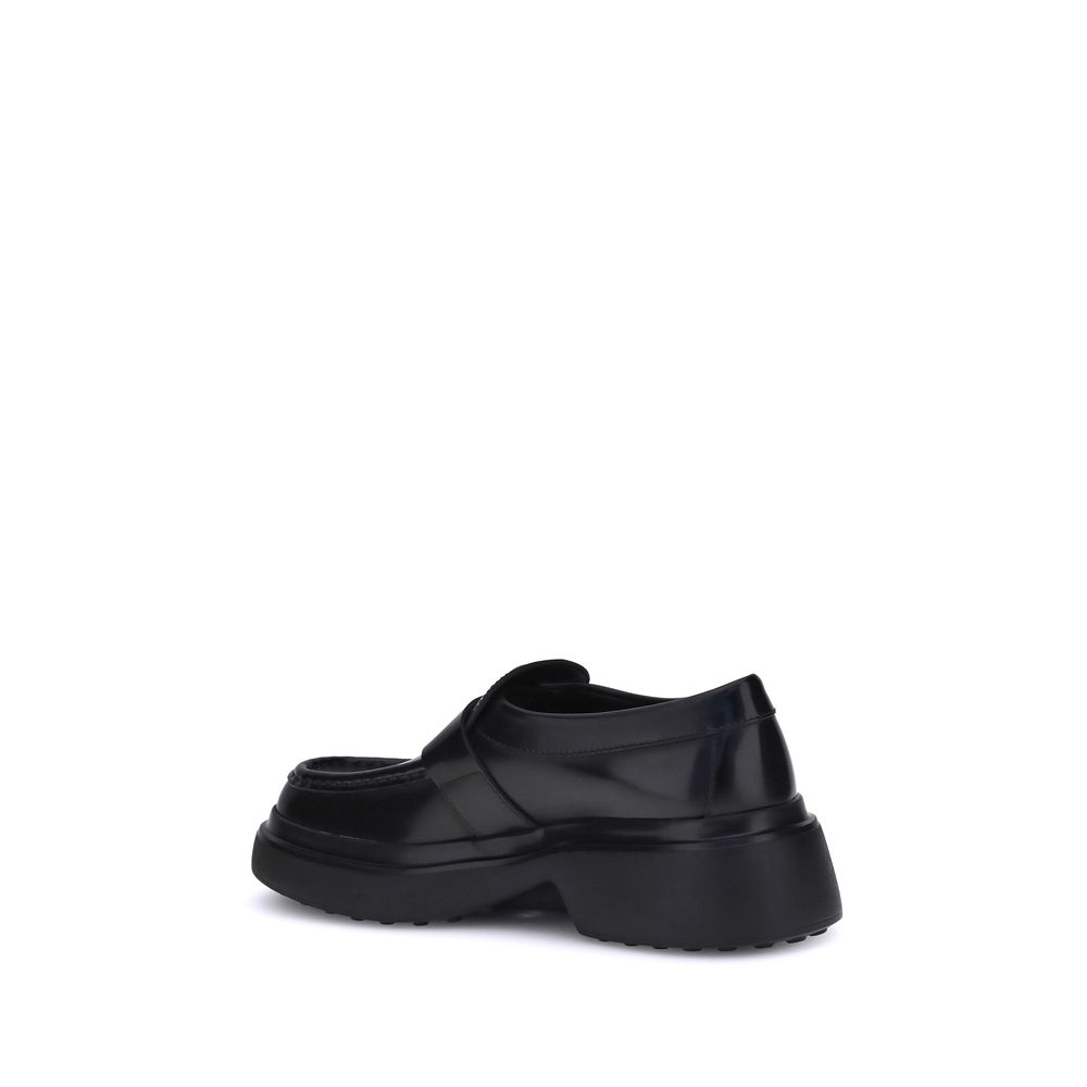 Back view of Tod's Black Rubber Platform Loafers crafted from soft nappa leather with metal rings and contemporary platform sole.