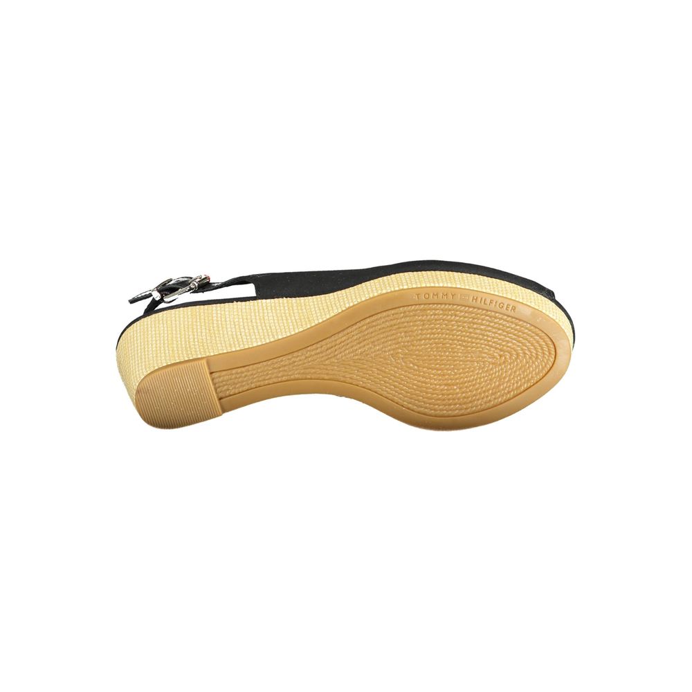 Bottom view of Tommy Hilfiger Black Leather Women Sandal with logo on sole and buckle closure.