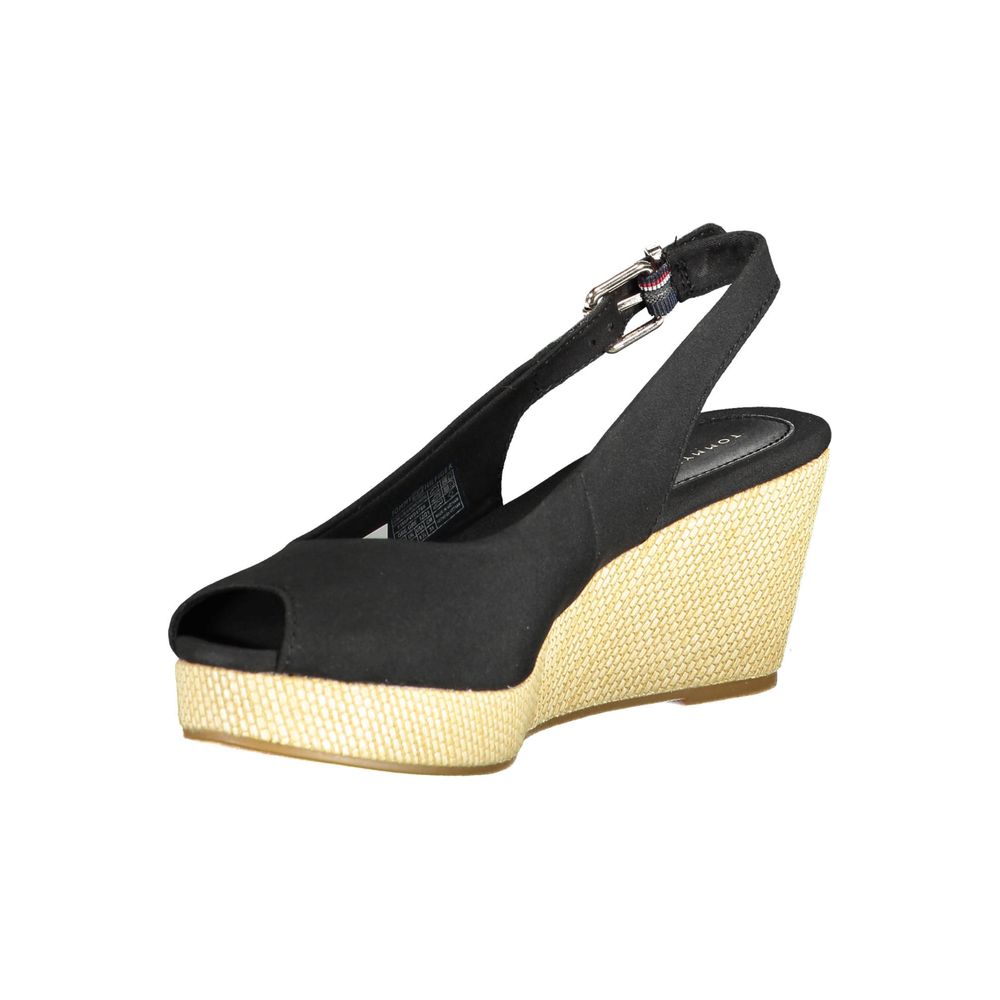 Tommy Hilfiger Black Leather Women Sandal with wedge heel and ankle buckle, featuring iconic logo detail and sleek design.