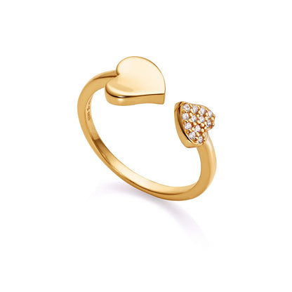 Gold heart-shaped ring with embedded crystals, showcasing elegant design and luxury craftsmanship.