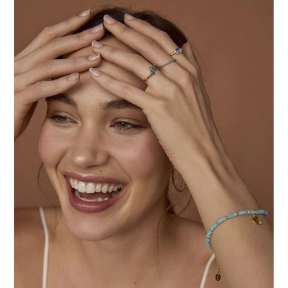 Smiling woman wearing VICEROY JEWELS Mod. 13136A013-33 ring, showcasing elegant design with blue bracelet and natural look, ideal for ladies.