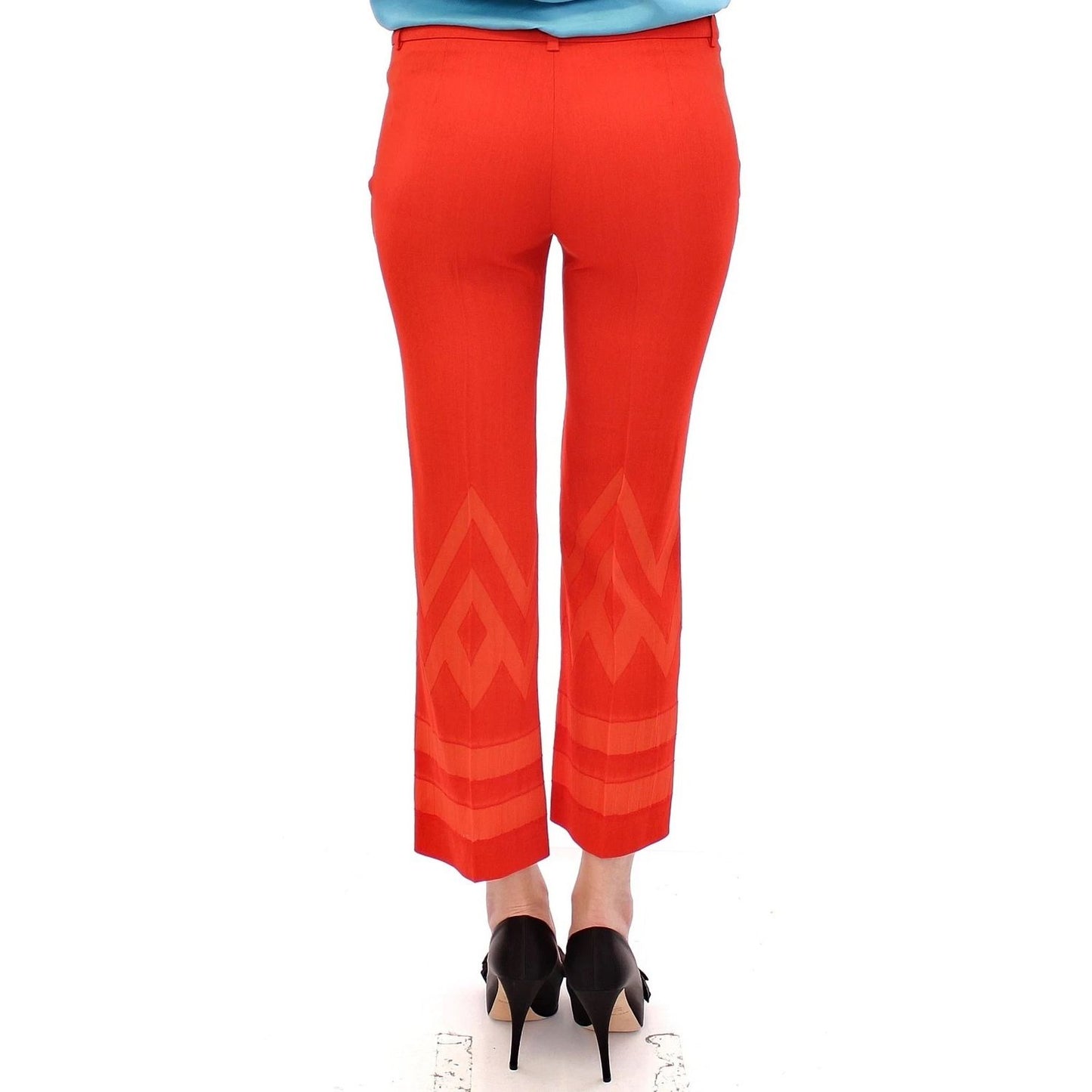 Person wearing Versace Collection Red Pants Cropped 3/4 Short Nude Capri Pants with unique leg pattern and cropped design.