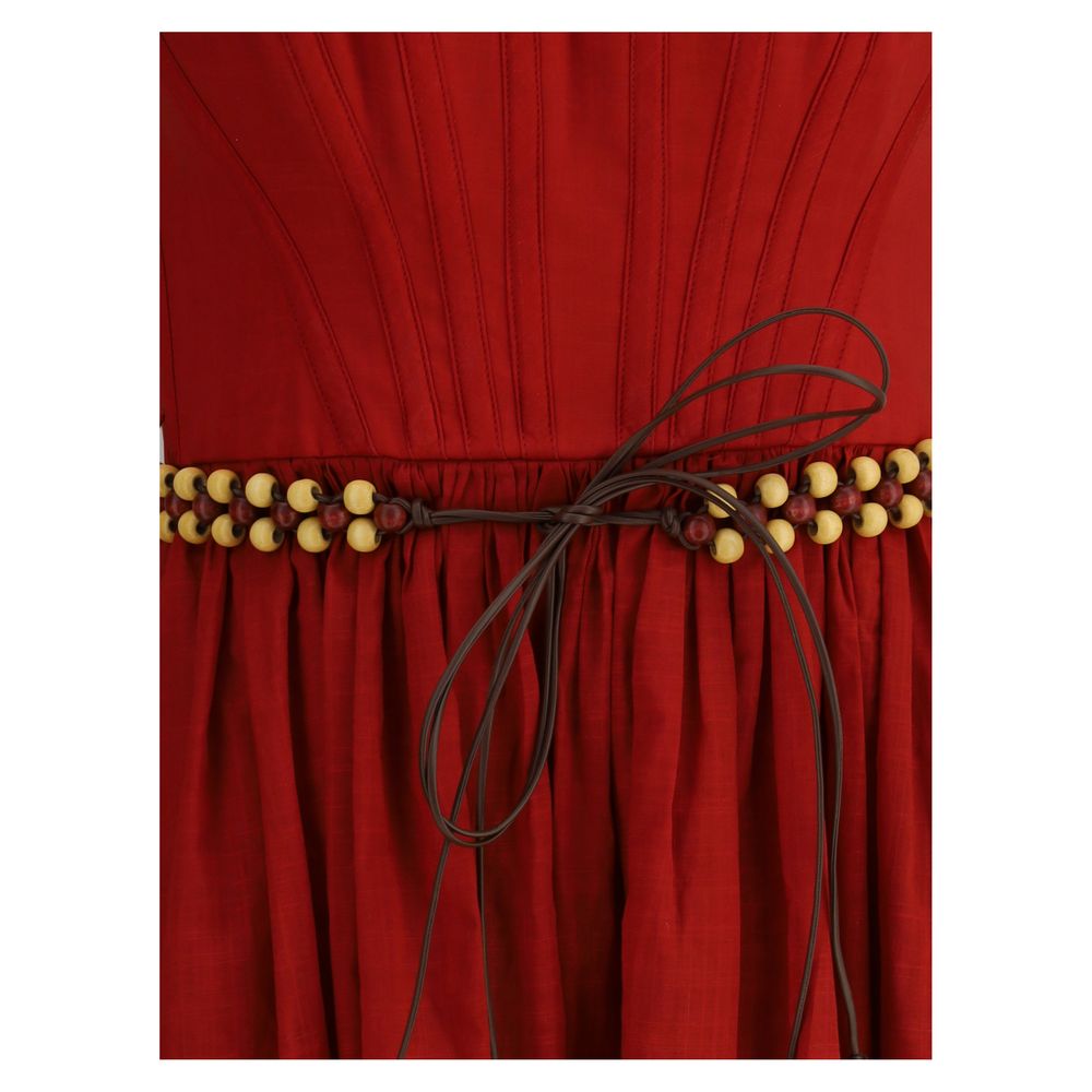 Zimmermann Rhiannon midi Dress close-up of gathered waist with beaded embellishment and ribbon tie detail in red fabric.